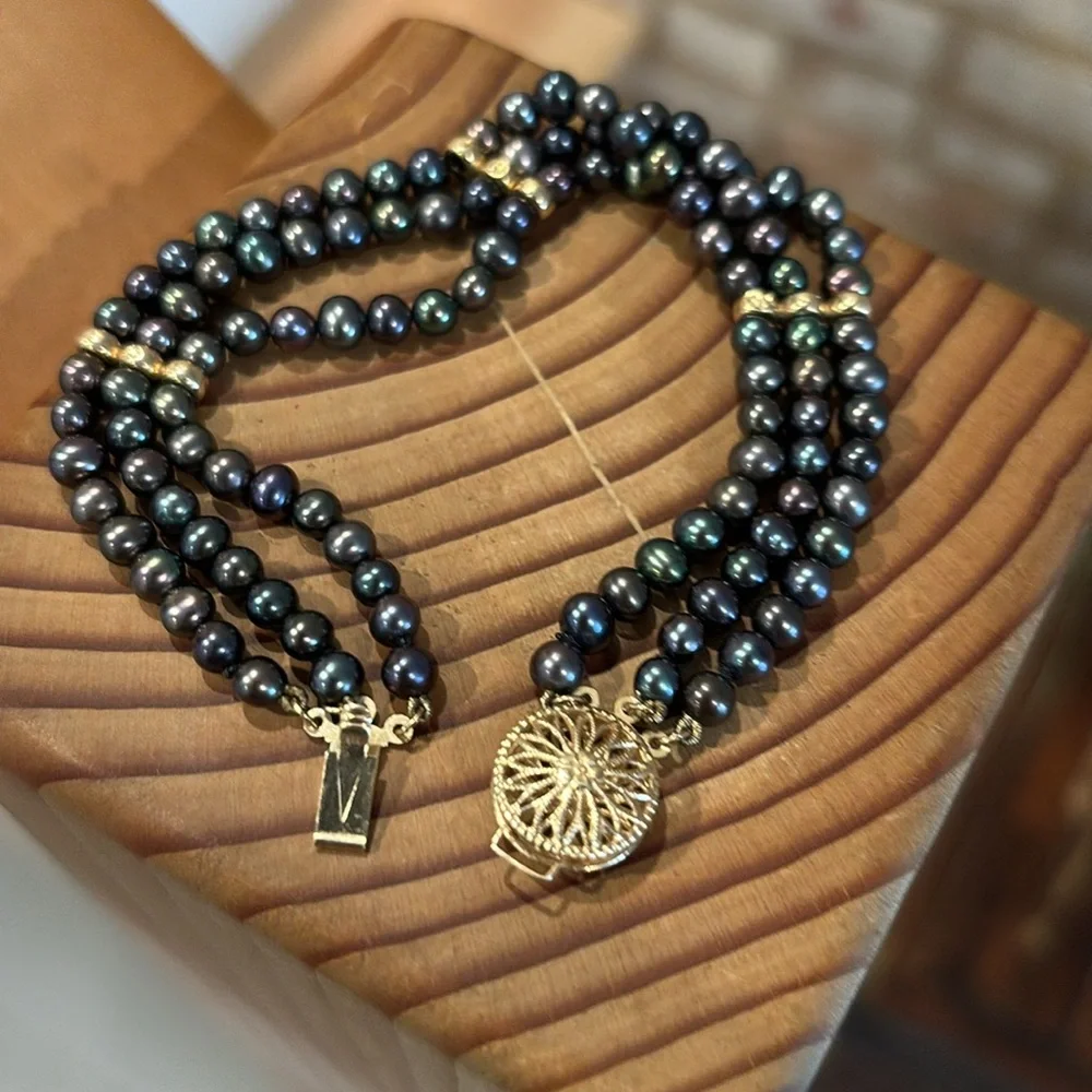 Tahitian black pearl bracelet with 14k gold filigree clasp.
